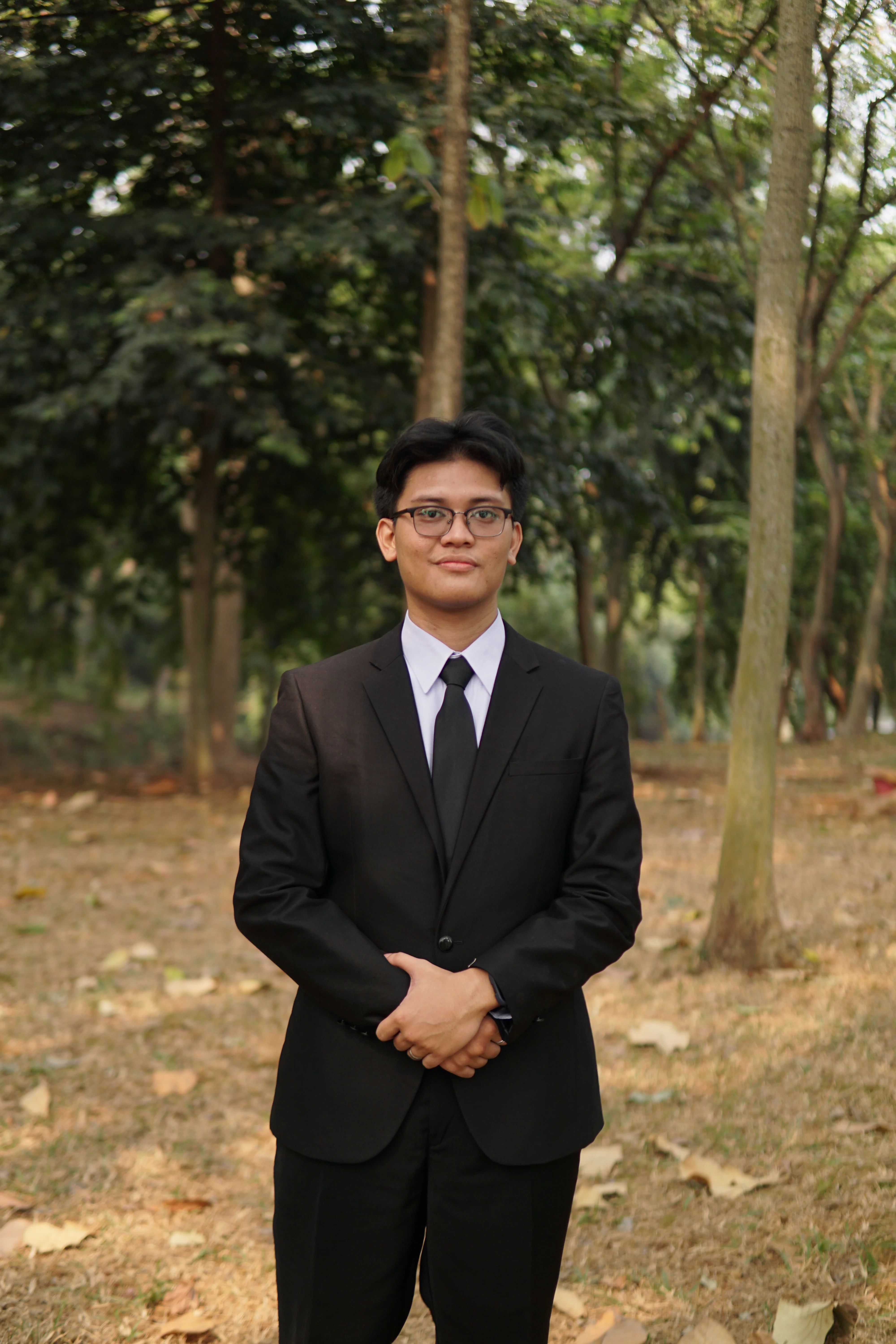 Hanif Zhafran in a dark suit, outdoors